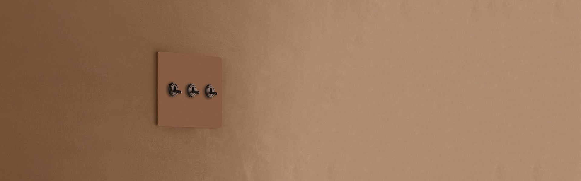 A minimalist brown wall plate with three black switches, seamlessly integrated into a textured brown wall.
